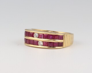 A yellow gold testing as 18ct ruby and diamond ring, the 18 princess cut rubies 0.20ct and the 2 brilliant cut diamonds 0.10ct, size L, 4 grams 