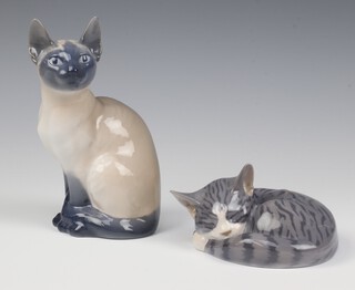 A Royal Copenhagen figure of a seated Siamese cat 3281 17cm, a sleeping cat 1025/422 9cm