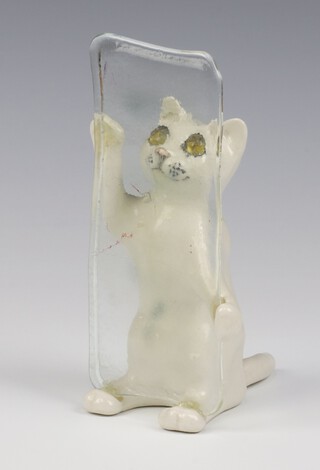 A Jenny Winstanley figure of a cat sitting on its back legs gripping a glass panel 16cm 