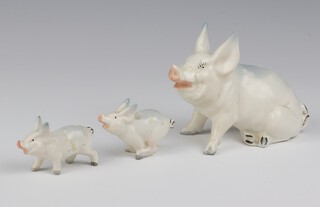 A Beswick seated pig 832 6cm a running piglet 4cm and a standing ditto 5cm 