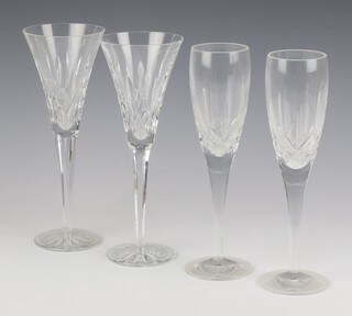 A pair of Waterford Crystal Glass Lismore pattern champagne flutes and a pair of flared neck wine glasses 