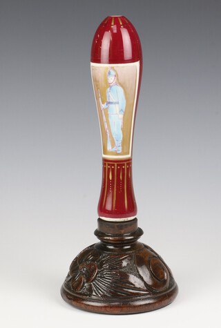 A Victorian porcelain beer pump decorated with Policeman raised on a wooden base 30cm 