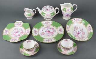 A Minton Green Cockatrice part tea set comprising 6 tea cups, 6 saucers, cream jug, milk jug and teapot with cover, a sugar bowl, 6 dessert bowls, 5 small plates, 6 side plates, 6 dinner plates, a dish, 2 sandwich plates and 2 oval vegetable dishes (1 a/f)