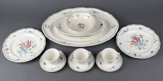 A Longchamp French dinner service comprising 7 coffee cups, 9 saucers, 4 small plates, 8 side plates (3 a/f), 9 dinner plates (1 cracked), 12 soup bowls, 2 circular serving plates, an oval meat plate, 3 oval dishes and 3 dessert bowls 