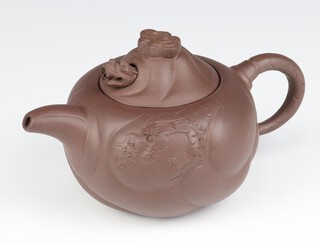 A Tan Ware Chinese teapot with incised decoration and having a reticulated dragon mask to the lid with impressed seal marks to the lid interior 9cm 