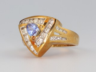 A yellow gold 18ct tanzanite and diamond ring, the triangular cut tanzanite 0.4ct, the brilliant cut diamonds 1.0ct, size P, 10.2 grams 