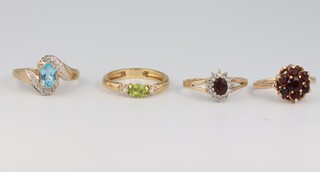 Four 9ct yellow gold gem set rings topaz and diamonds, peridot and diamonds, ruby and garnet cluster, sizes K, L, M 1/2 and N 