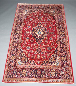 A red and blue ground North Persian rug with central medallion 236cm x 140cm  