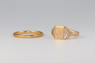 A 22ct yellow gold wedding band, size N 1/2, 2.6 grams and a 9ct yellow gold signet ring 2.2 grams, size K