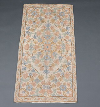 A cream, turquoise and floral patterned Kashmiri panel 130cm x 61cm 