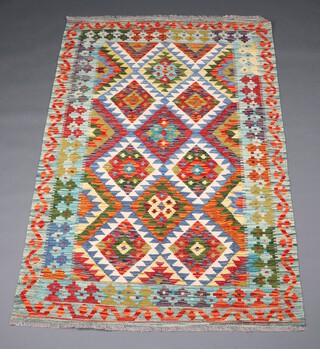 A white, blue, tan and turquoise ground Chobi Kilim rug with all over diamond design 186cm x 121cm 