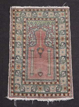 A brown and green ground Persian prayer rug 93cm x 58cm (in wear)