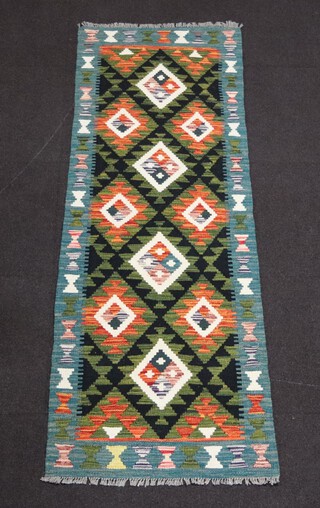 A black, white and green ground Maimana Kilim runner 192cm x 64cm  