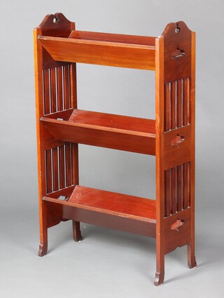 A Liberty style mahogany 3 tier book trough with pierced panels to the sides 103cm x 63cm x 25cm 