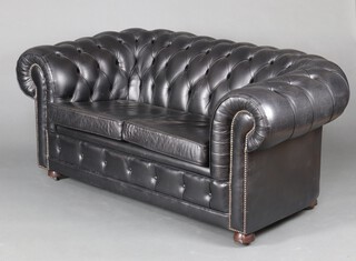 A Chesterfield settee upholstered in black buttoned leather 75cm h x 155cm w x 89cm d (seat 90cm x 45cm) 