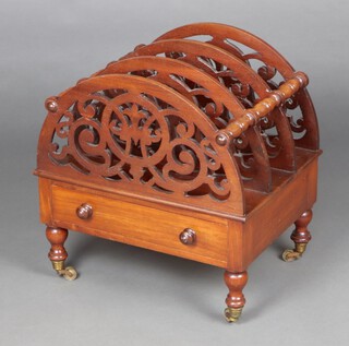 A Victorian mahogany 3 section Canterbury with pierced panels, the base fitted a drawer, raised on brass caps and casters 50cm h x 48cm w x 38cm d 