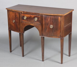 A 19th Century Georgian style mahogany bow front sideboard, fitted a drawer flanked by cupboards enclosed by panelled doors, raised on square tapered supports 92cm h x 122cm w x 54cm d  