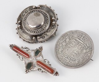 An Edwardian silver and hardstone brooch, an Etruscan style ditto and a Victorian silver half crown brooch, gross weight 26 grams 