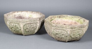 A pair of well weathered octagonal garden planters with panel and floral decoration 30cm h x 64cm w x 63cm d  