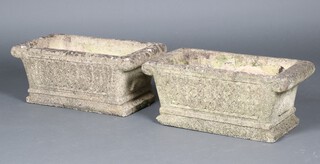 A pair of well weathered rectangular garden plant troughs with panelled decoration 27cm h x 64cm w x 33cm d 