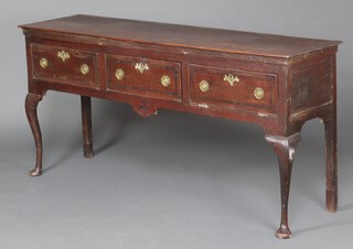 A Georgian oak dresser base fitted 3 drawers, (the right hand drawer fitted a hinge for fall front), raised on cabriole supports 88cm h x 161cm w x 48cm d 