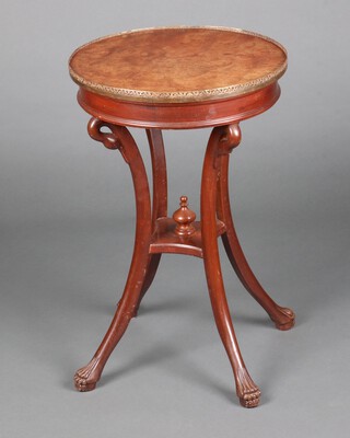 A Regency style circular figured walnut mahogany occasional table with pierced brass gallery, raised on swan head supports with undertier and paw feet 68cm h x 44cm diam. 