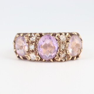 A 9ct yellow gold amethyst and diamond 3 stone ring, the amethysts approx 2ct, the diamonds 0.05ct, size M, 4.1 grams 