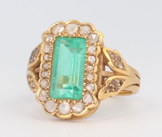 A yellow gold, testing as 9ct, Art Deco cocktail ring  set with a rectangular green paste stone and brilliant cut diamonds 0.5ct (3 missing) 6.4 grams, size J 1/2