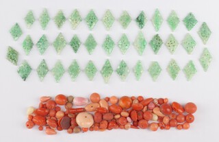 A quantity of loose coral and jade beads 