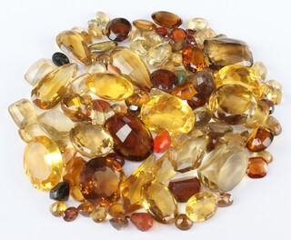 A quantity of loose polished stones including citrine, quartz etc