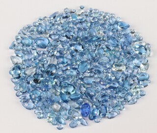 A quantity of topaz and other blue polished stones, loose