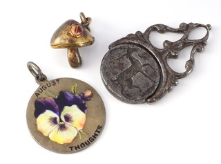 An Edwardian silver guilloche enamel pendant decorated with a pansy, a swivel seal and a novelty charm 