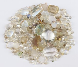 A quantity of loose polished stones including moonstone, quartz, etc 