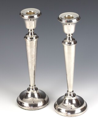 A pair of tapered silver candlesticks Birmingham 1929, 31cm, weighted 