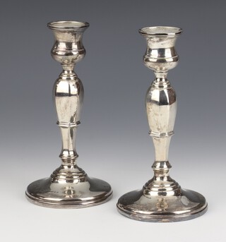 A pair of Victorian style octagonal waisted silver candlesticks London 1933, 18cm, weighted