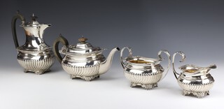 A Georgian style silver tea set with demi-fluted decoration on scroll and shell feet, Birmingham 1928 and 1938 comprising teapot, coffee pot, sugar bowl, cream jug, makers Barker Brothers Silver Ltd gross weight 1964 grams