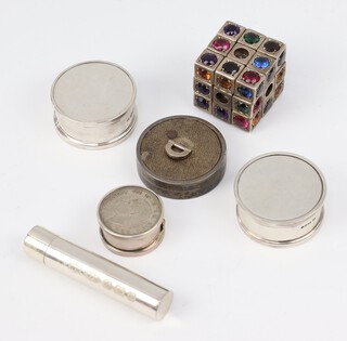 A circular silver engine turned pill box London 1958, 3 other boxes, a cylindrical tube and a "gem" set rubic cube 2.5cm 