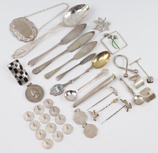 A 2002 commemorative silver spoon, a pair of silver cufflinks, 2 silver MG pendants, a plain spirit label and minor silver curios, gross weight 268 grams