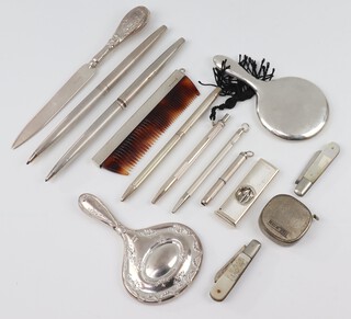 A silver miniature hand mirror, rubbed marks and minor silver mounted accessories 