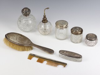 An Edwardian silver mounted toilet bottle 12cm (chipped), 3 silver mounted bottles, an atomiser and comb, toilet box and hair brush 