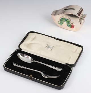 A silver plated and enamelled Portmeirion "The Very Hungry Caterpillar" money bank 12cm and a cased silver spoon and fork, 40 grams 