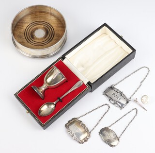 A silver mounted coaster London 1994 13cm, a silver golf tea and ball marker, 3 spirit labels - Port, Brandy and Cognac, a silver egg cup and spoon, weighable silver 68 grams