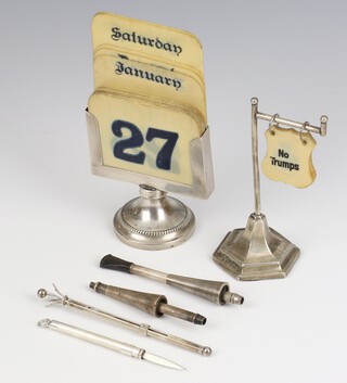 A silver desk top table calendar Birmingham 1924, a bridge marker, swizzle stick, tooth pick and cigarette holder 