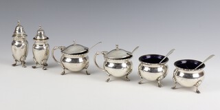 A silver condiment comprising 2 mustard pots, 2 salts, 2 peppers, 4 spoons, Birmingham 1926, 328 grams 