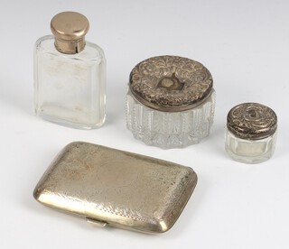 A silver engraved cigarette case Birmingham 1921, 3 silver lidded toilet bottles, weighable silver 64 grams