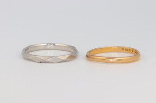 A platinum wedding band size O, 2.9 grams, a 22ct yellow gold ditto size M 1.8 grams 