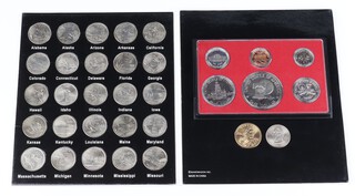 A cased set of fifty states quarters, a cased proof coin set and 2 coins.