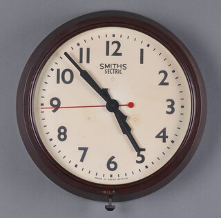 A Smiths Sectric electric wall clock with 29cm painted dial, Arabic numerals, contained in a brown Bakelite case marked 1011.C  