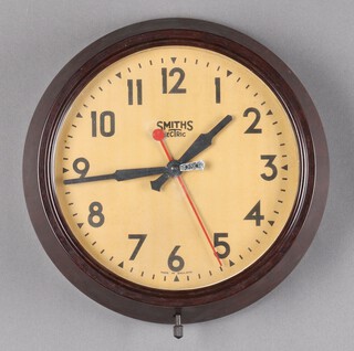 A Smiths Sectric electric wall clock with 22cm painted dial, Arabic numerals contained in a brown Bakelite case 