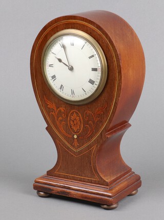 An Edwardian timepiece, the 9cm enamelled dial with Roman numerals, contained in a shaped inlaid mahogany case 22cm h x 13cm w x 7cm d (with key)